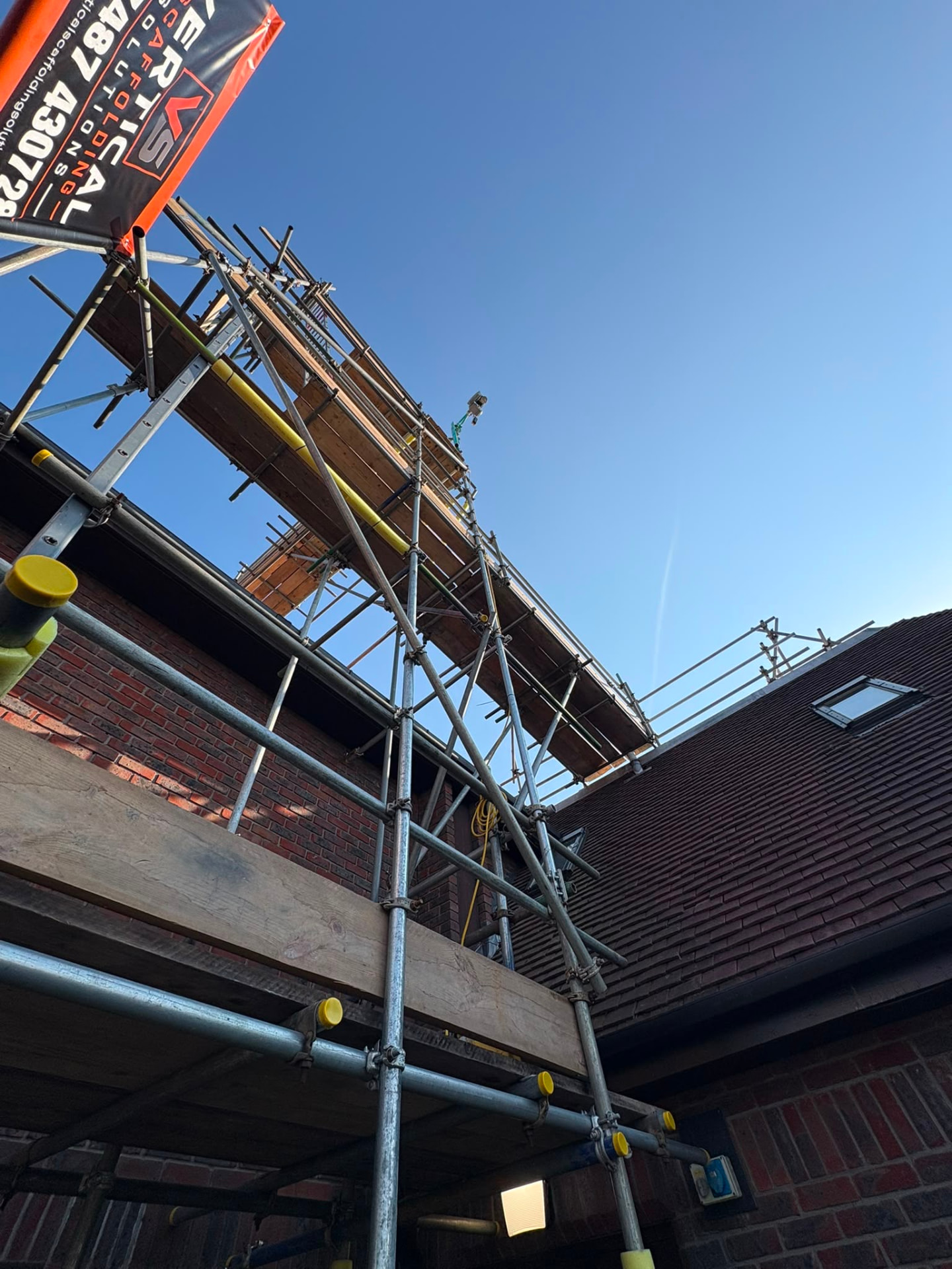 Multi-lift access scaffolding with boarded platforms at each level